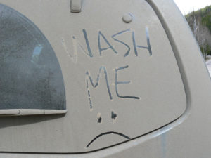 Wash Me written in dirt on car